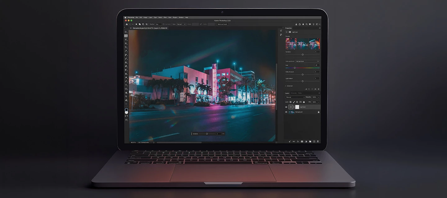 A modern laptop with the latest version of Photoshop open