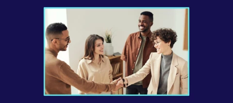 A picture of four people looking at each other; two people offering each other a handshake
