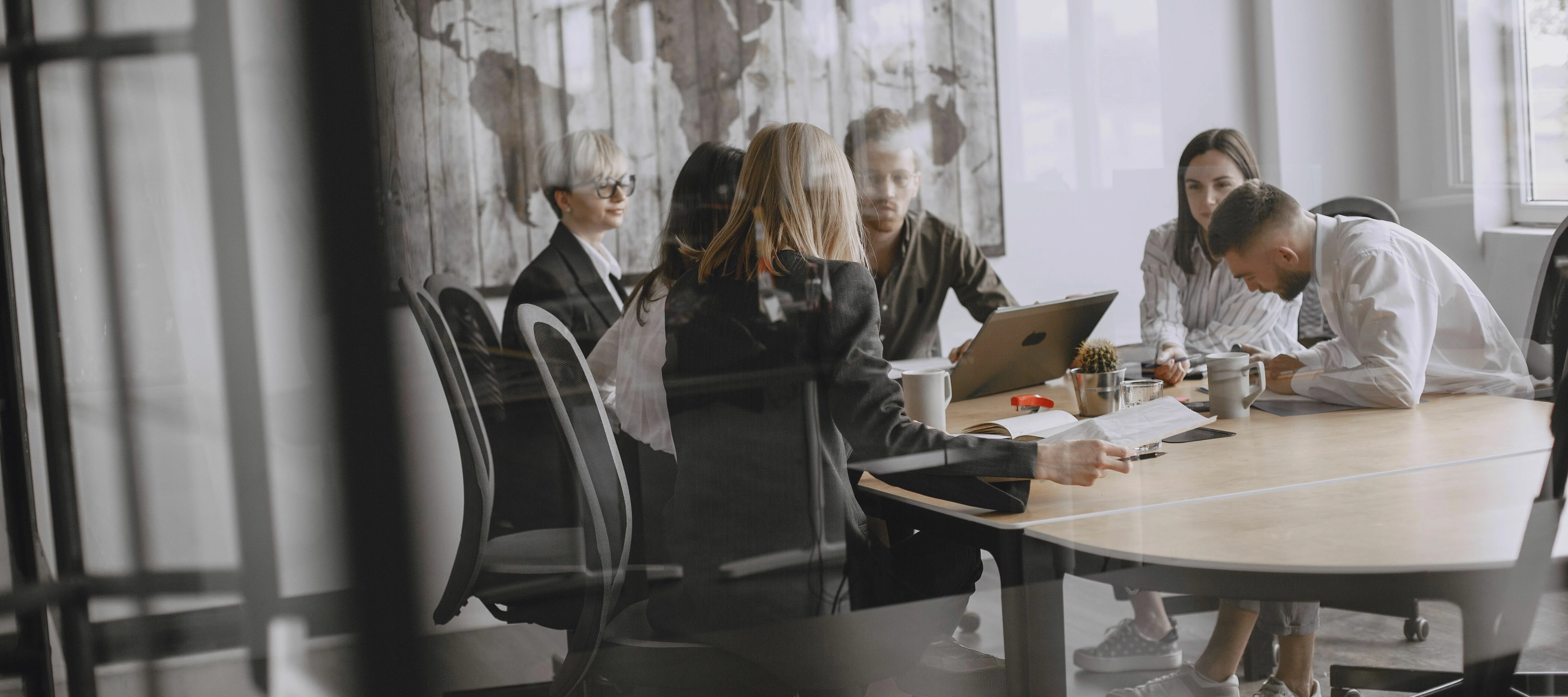 user group with coworkers behind glass