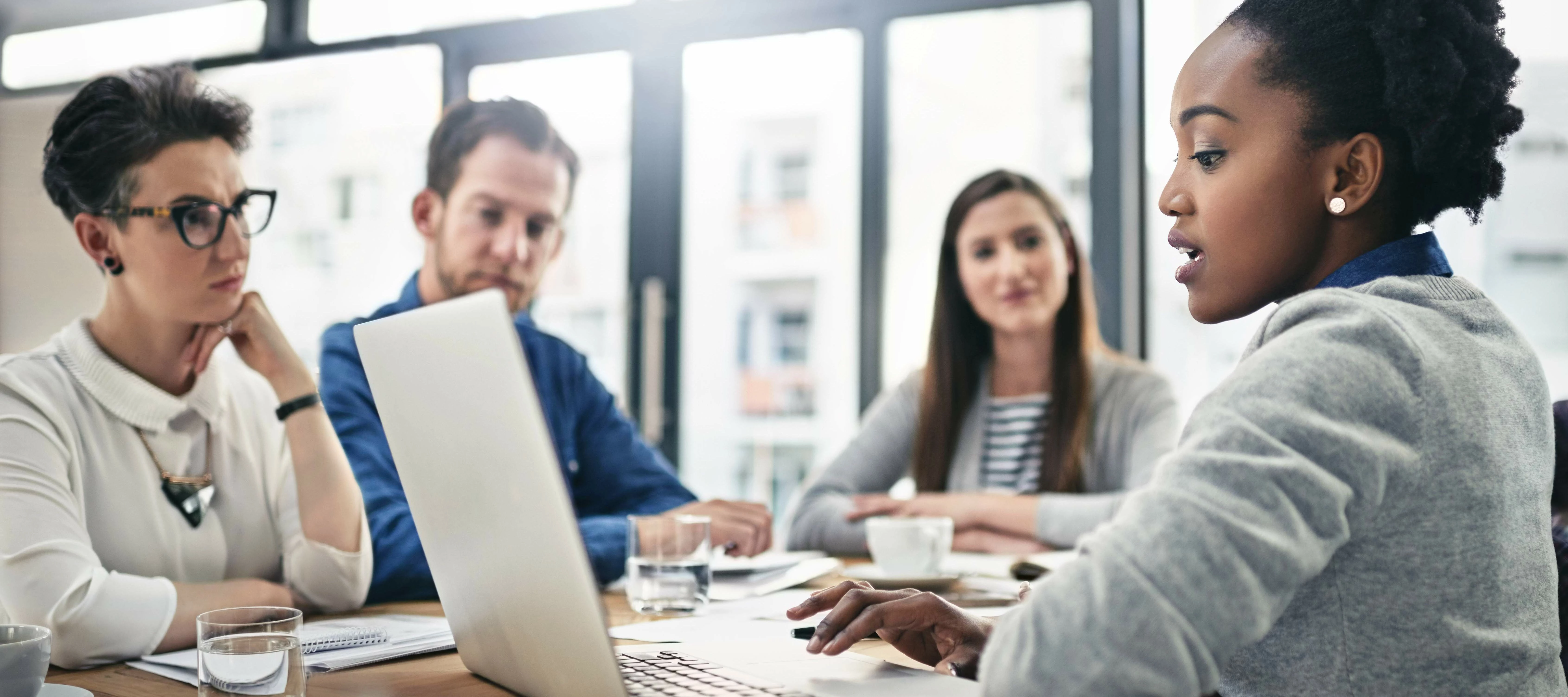 Business meeting showing ideas on a laptop