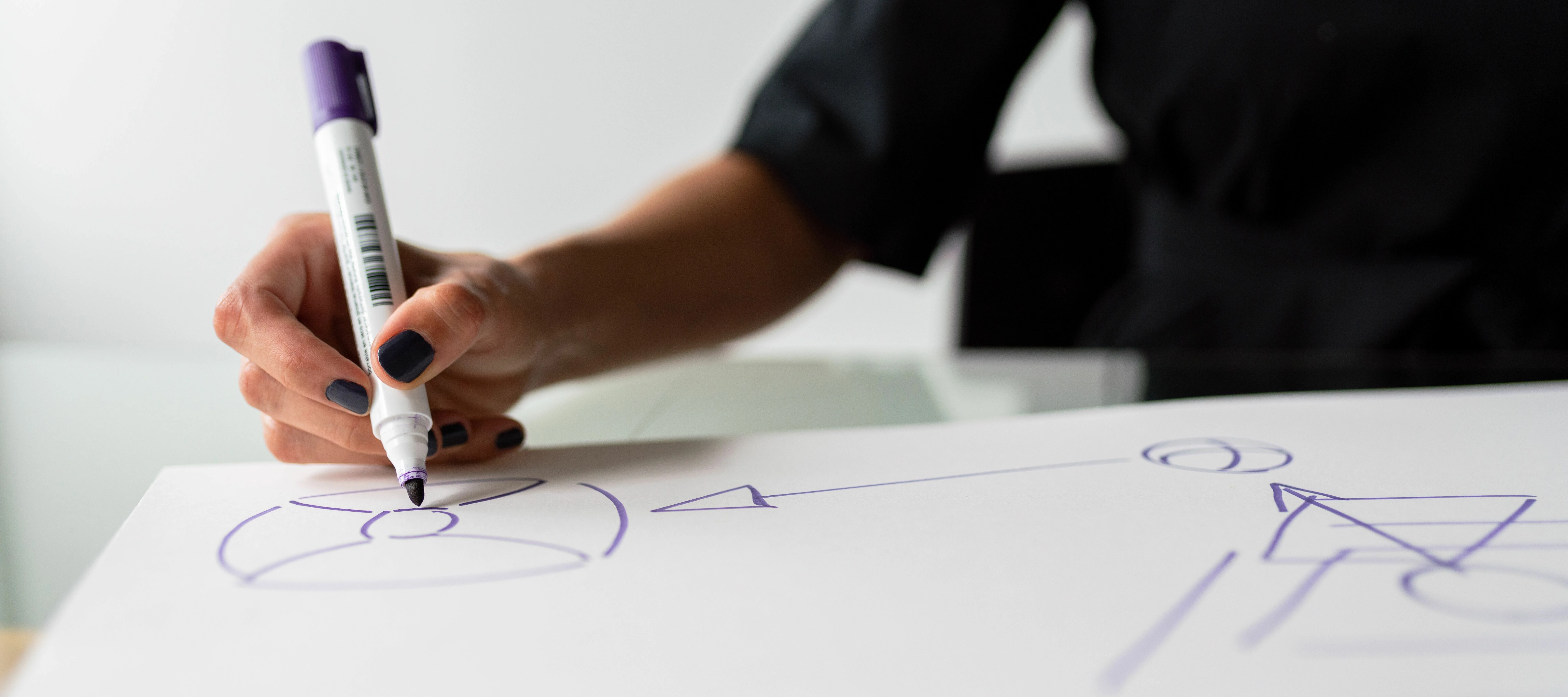 person writing a change management diagram and flow