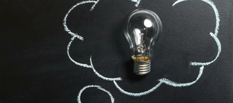 lightbulb on a chalkboard that is surrounded by a think bubble