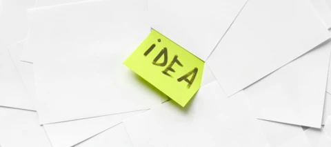 yellow idea post it note on other paper