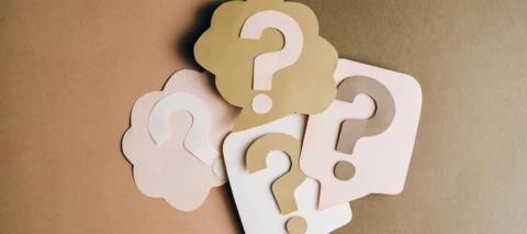pile of question marks on construction paper
