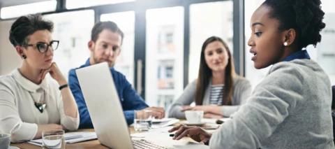 Business meeting showing ideas on a laptop